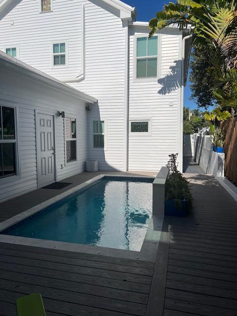 1116 Truman Avenue, Unit 1 Key West, FL 33040 - Photo 17 of 18 a view of a balcony with chair and a potted plant