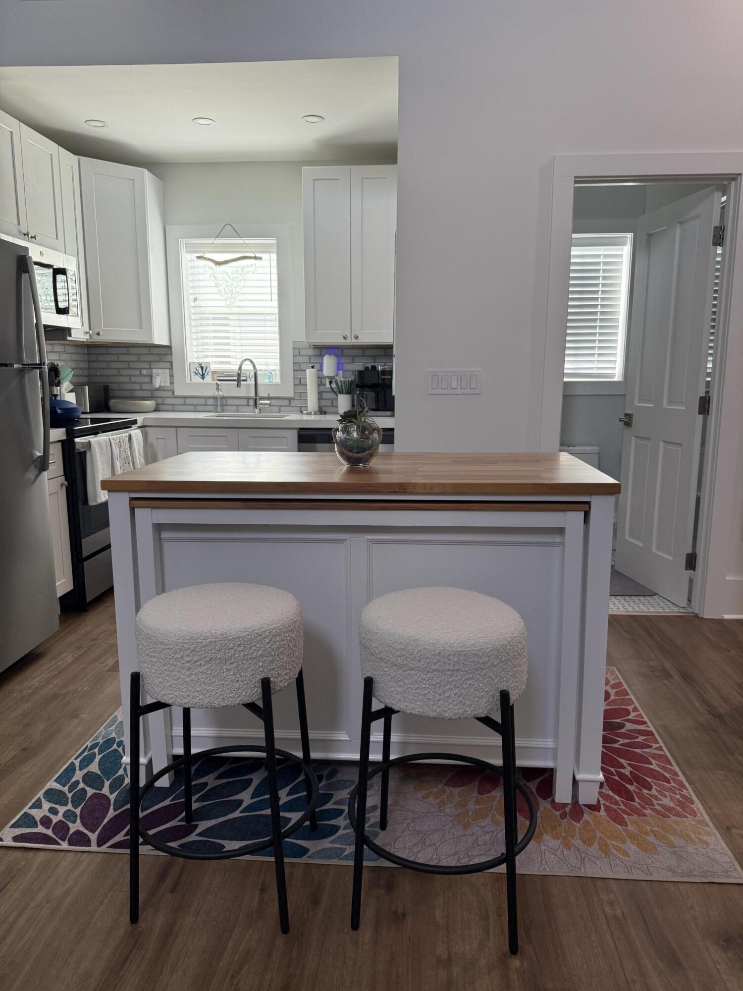 1116 Truman Avenue, Unit 1 Key West, FL 33040 - Photo 3 of 18 a kitchen with a dining table and chairs
