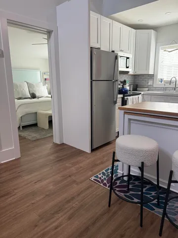 a kitchen with a refrigerator a stove a sink and a cabinets