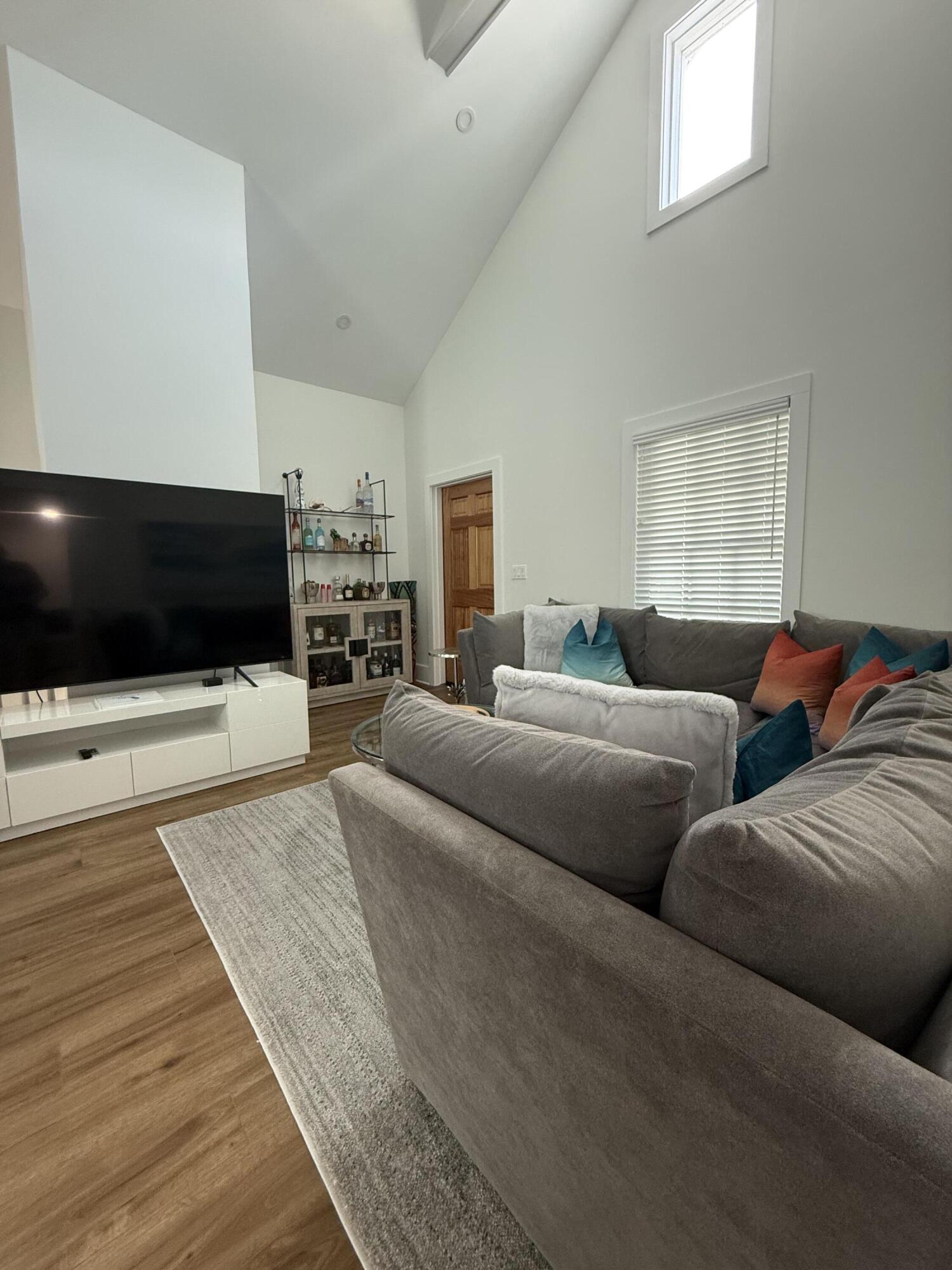 1116 Truman Avenue, Unit 1 Key West, FL 33040 - Photo 9 of 18 a living room with furniture and a flat screen tv