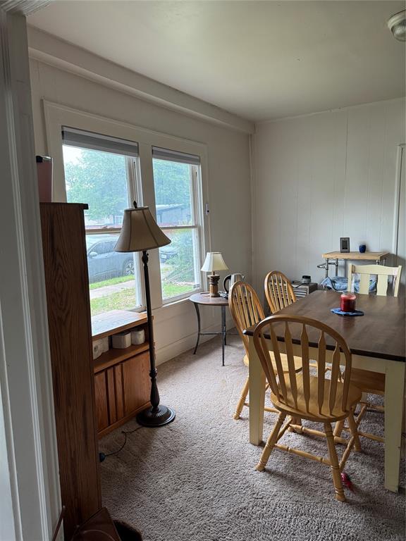 2300 Lyle Avenue Waco, TX 76708 - Photo 7 of 23 Dining area featuring light colored carpet and a decorative wall