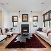 a living room with furniture fireplace and window