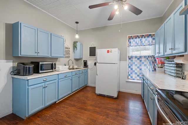 a kitchen with a refrigerator and a stove top oven