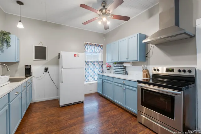 a kitchen with a stove a sink and a refrigerator