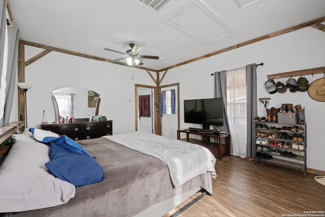 a bedroom with a bed and wooden floor