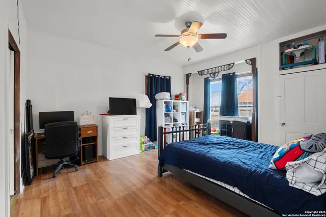 a bedroom with furniture and a flat screen tv
