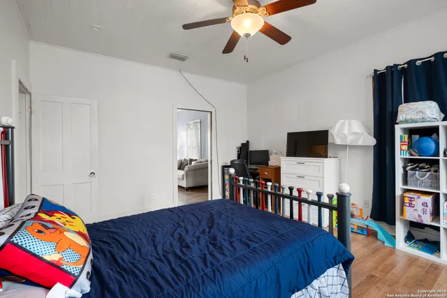 a bed room with bed and a chandelier
