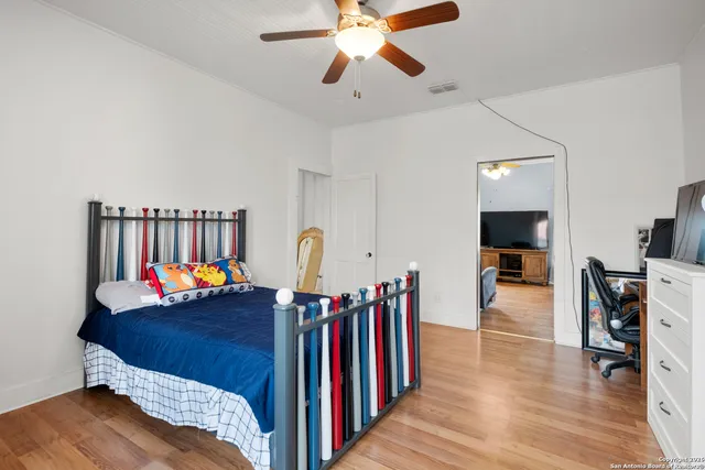 a view of a hallway with wooden floor and entryway