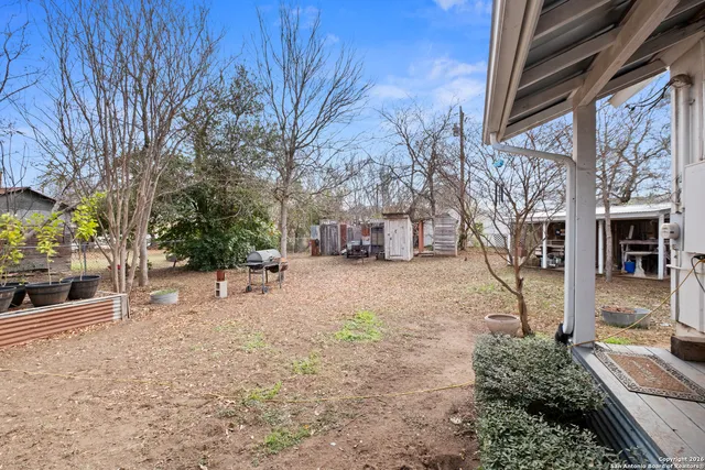 a view of a house with backyard and sitting area