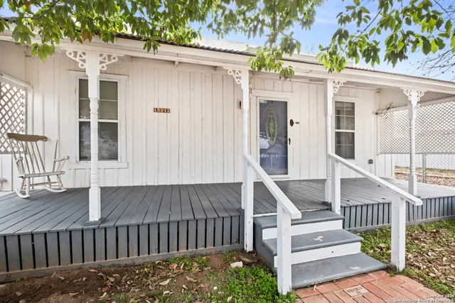a view of a house with wooden floor and fence