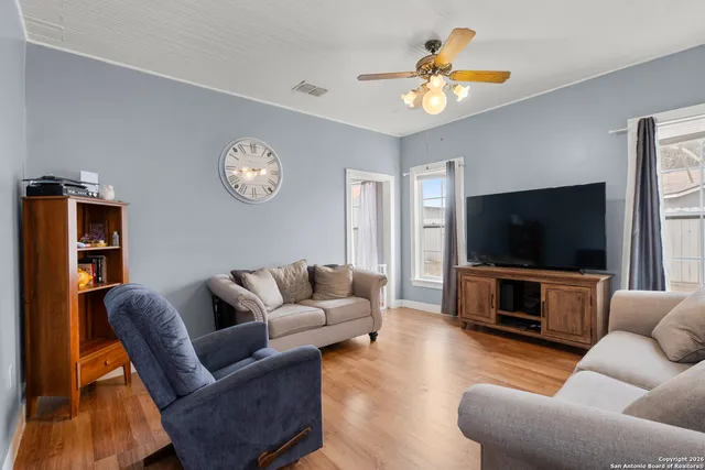 a living room with furniture and a flat screen tv