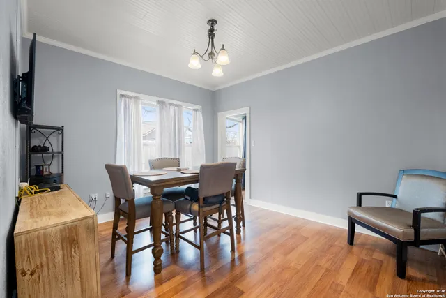 a view of a dining room with furniture and wooden floor
