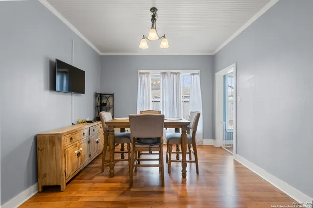 a view of a a dining room with furniture window and wooden floor