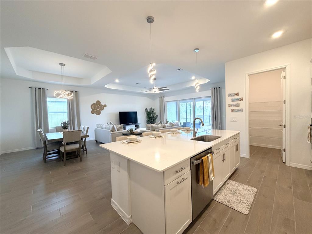 13081 Tulum Loop Venice, FL 34293 - Photo 9 of 48 a large white kitchen with a large island in it