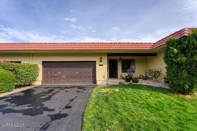 a front view of a house with garden