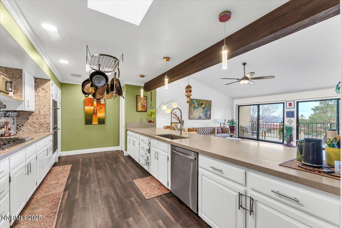 3415 Skyline Boulevard Reno, NV 89509 - Photo 15 of 49 a large kitchen with stainless steel appliances granite countertop a lot of counter space and wooden floors