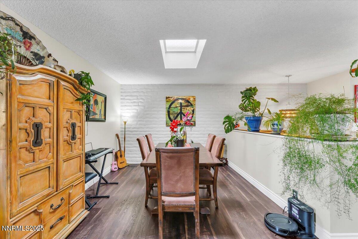 3415 Skyline Boulevard Reno, NV 89509 - Photo 21 of 49 a view of a dining room with furniture one side kitchen view and wooden floor
