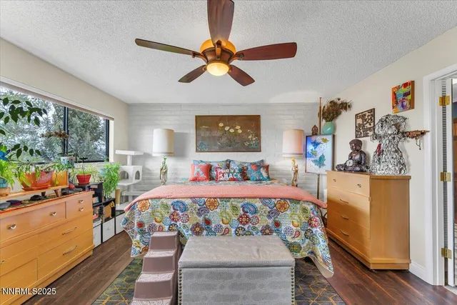 a bedroom with bed and wooden floor