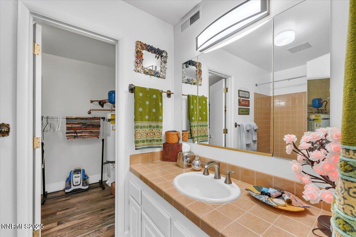 3415 Skyline Boulevard Reno, NV 89509 - Photo 40 of 49 a en suite bathroom with a double vanity sink and a mirror