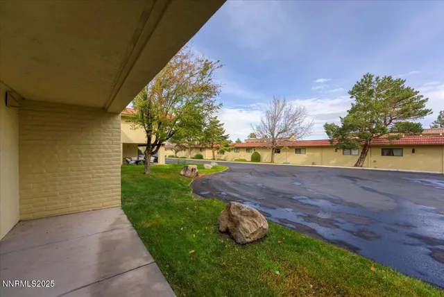 a view of yard with swimming pool and green space