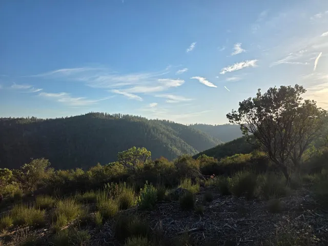 a view of a lake in middle of the sunset