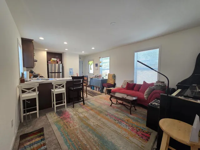 a kitchen with refrigerator cabinets and wooden floor