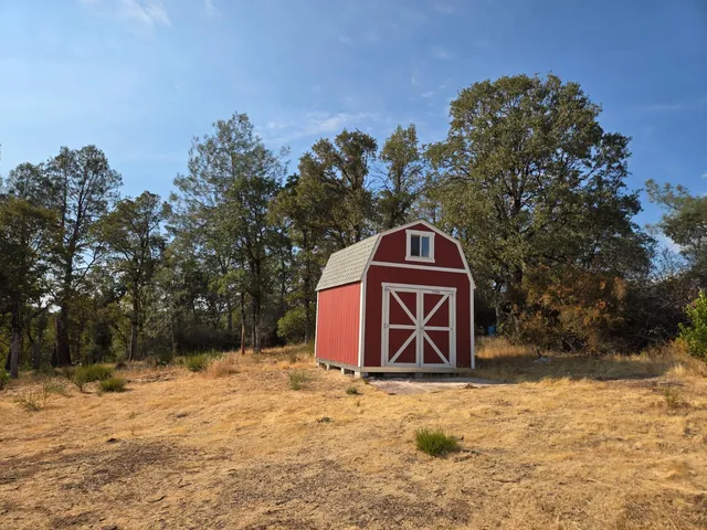 a backyard of a house with table and chairs