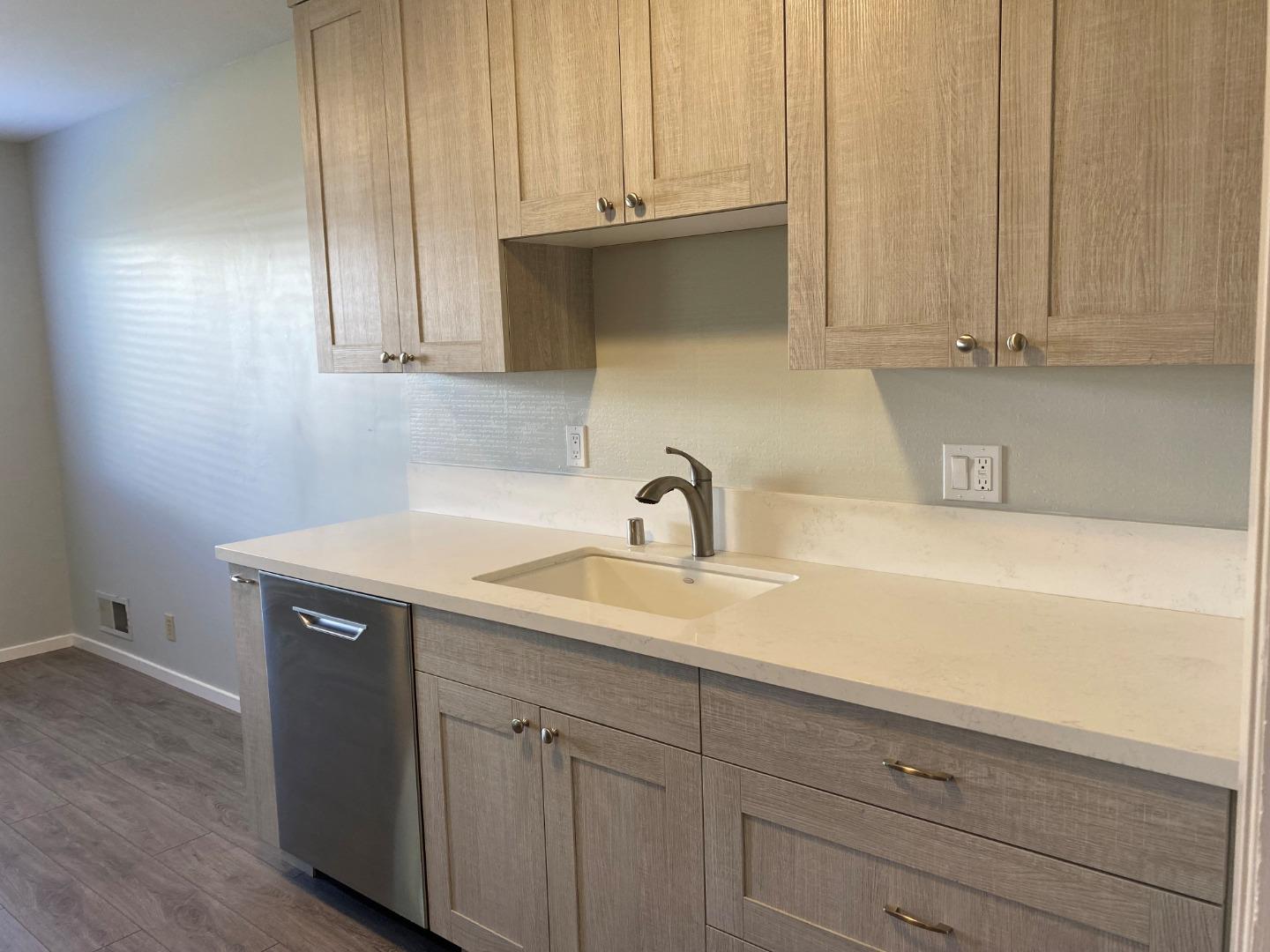 625 Comet Drive Foster City, CA 94404 - Photo 4 of 15 a kitchen with stainless steel appliances granite countertop white cabinets and a sink