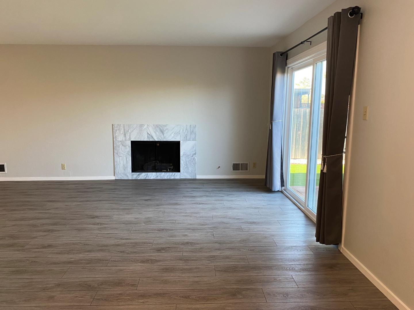 625 Comet Drive Foster City, CA 94404 - Photo 6 of 15 a view of an empty room with wooden floor and a window