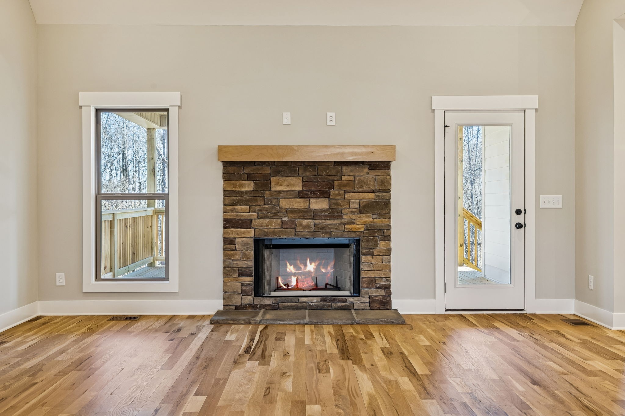 1183 Hangar Road Springfield, TN 37172 - Photo 22 of 69 a view of an empty room with wooden floor fireplace and a window