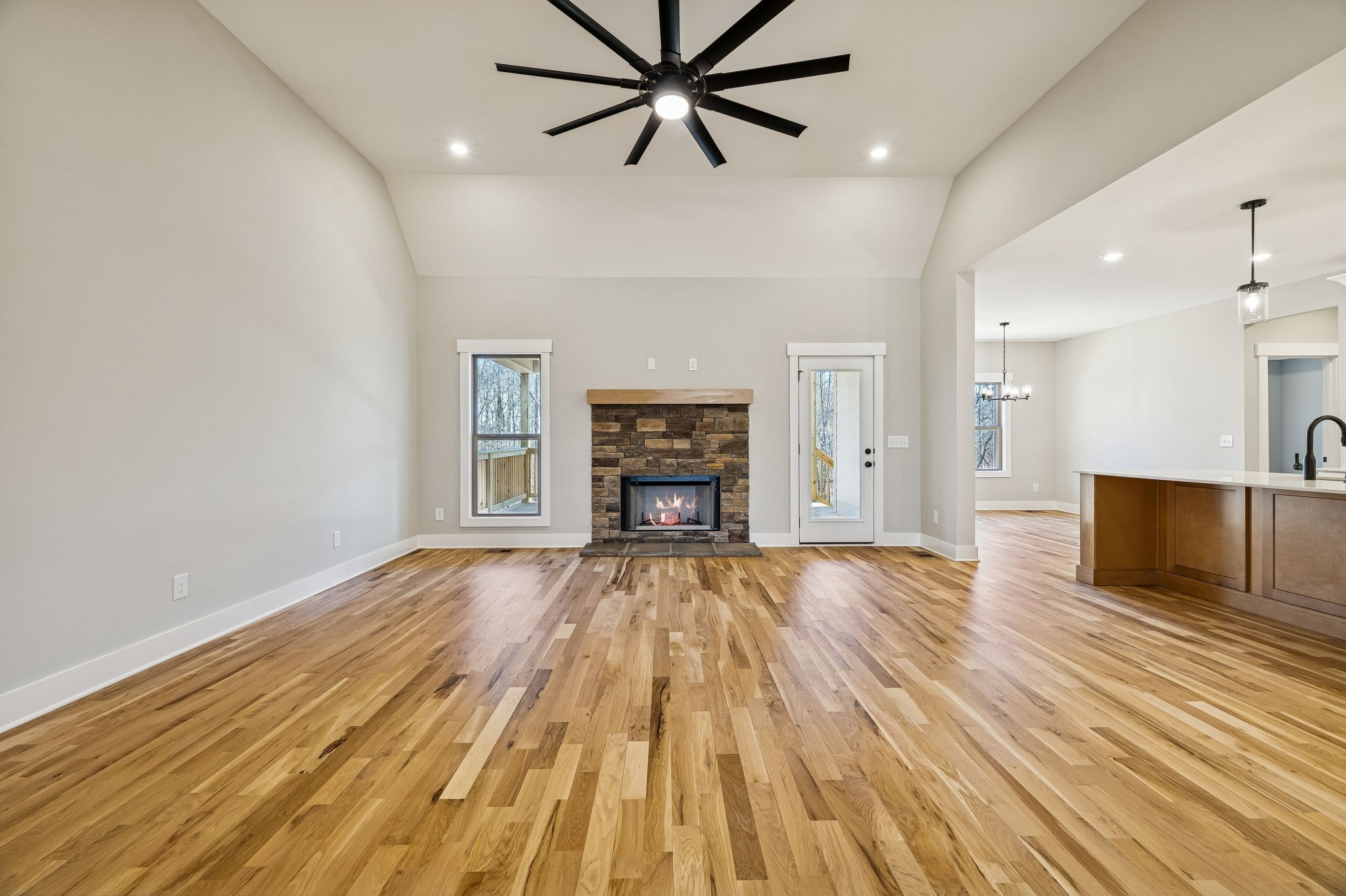1183 Hangar Road Springfield, TN 37172 - Photo 23 of 69 an empty room with wooden floor a ceiling fan and kitchen view