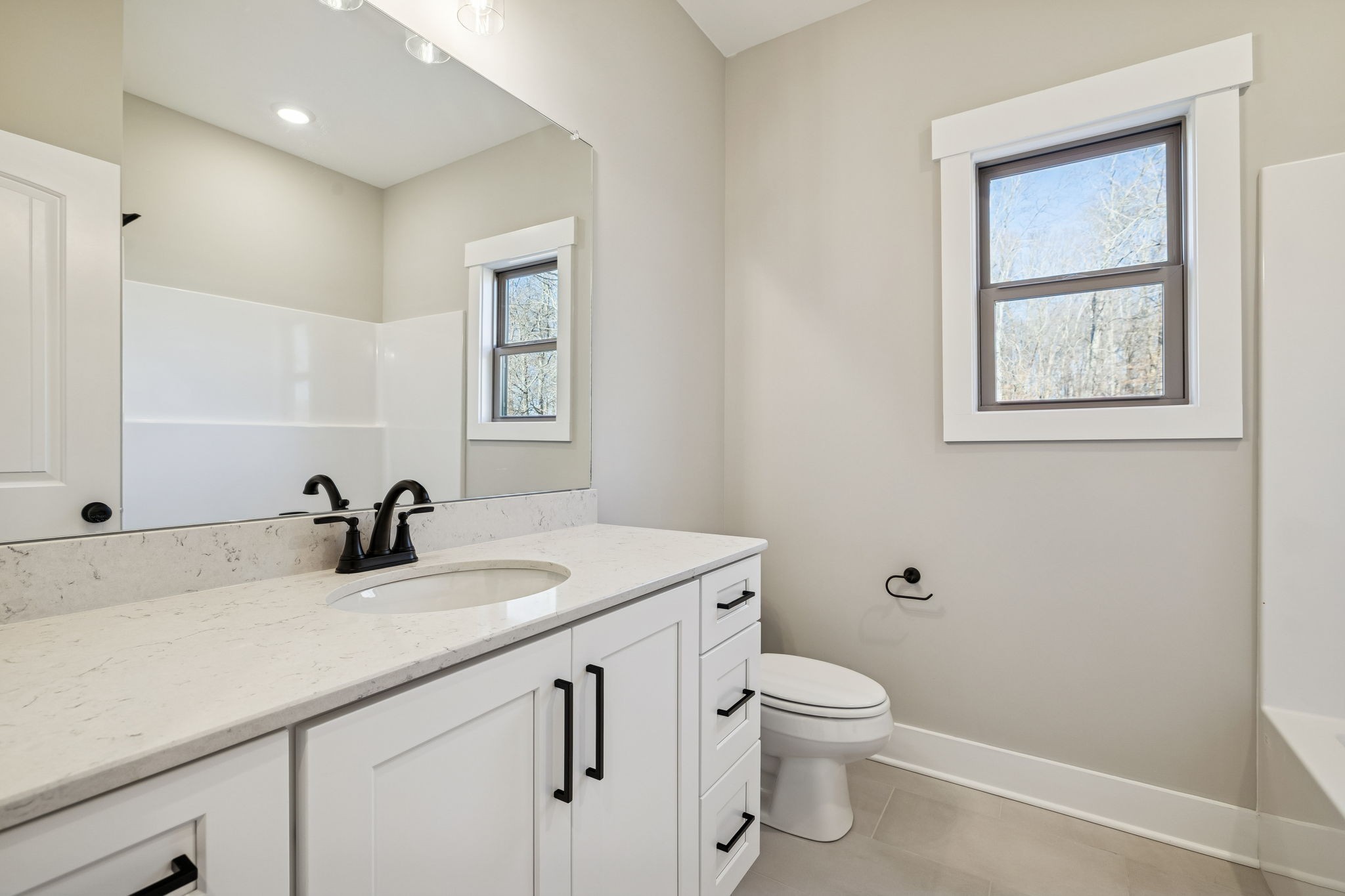 1183 Hangar Road Springfield, TN 37172 - Photo 37 of 69 a bathroom with a granite countertop sink a toilet and a mirror
