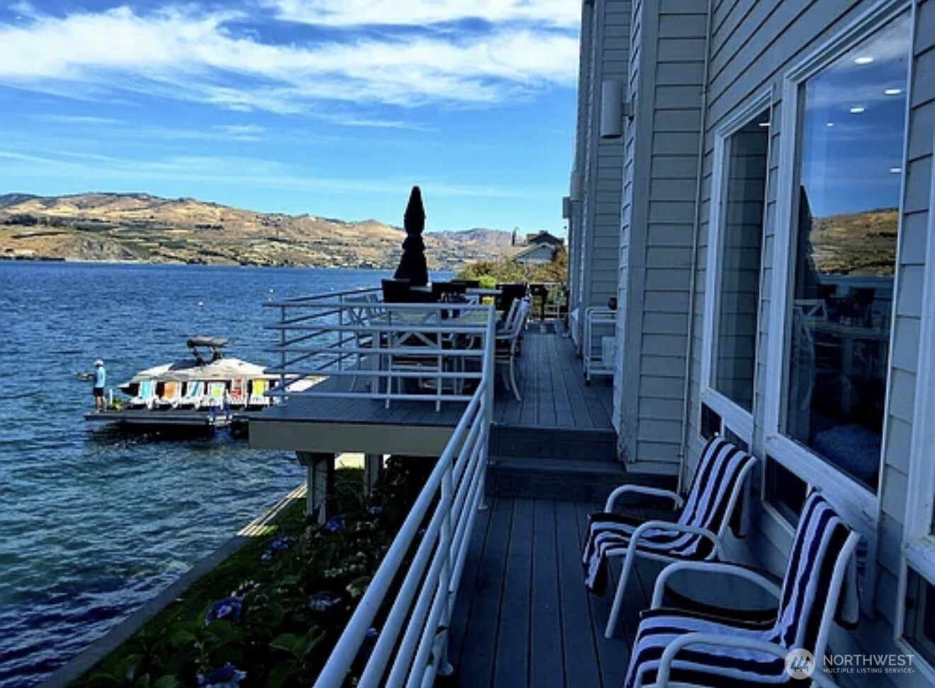 2685 South Lakeshore Road Chelan, WA 98816 - Photo 6 of 16 a view of a balcony with two chairs and a potted plant
