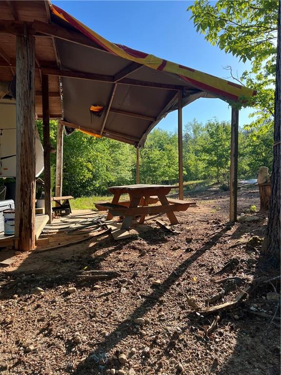 271 Pebble Hill Road Southeast Milledgeville, GA 31061 - Photo 3 of 8 a view of a patio with table and chairs under an umbrella