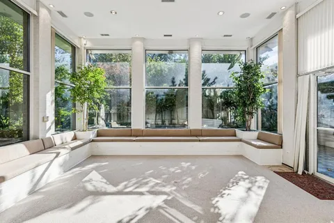 a living room filled with furniture and a large window