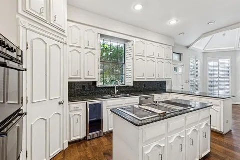 a kitchen with stainless steel appliances a stove sink and cabinets