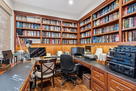 a view of a workspace with furniture and book shelf