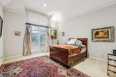 a bed sitting in a bedroom next to a window