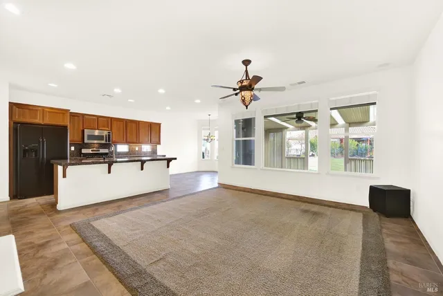 a living room with furniture and kitchen view