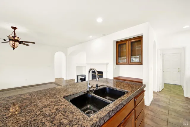 a hallway with granite countertop a refrigerator and a stove