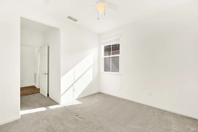 a view of a big room with closet and windows