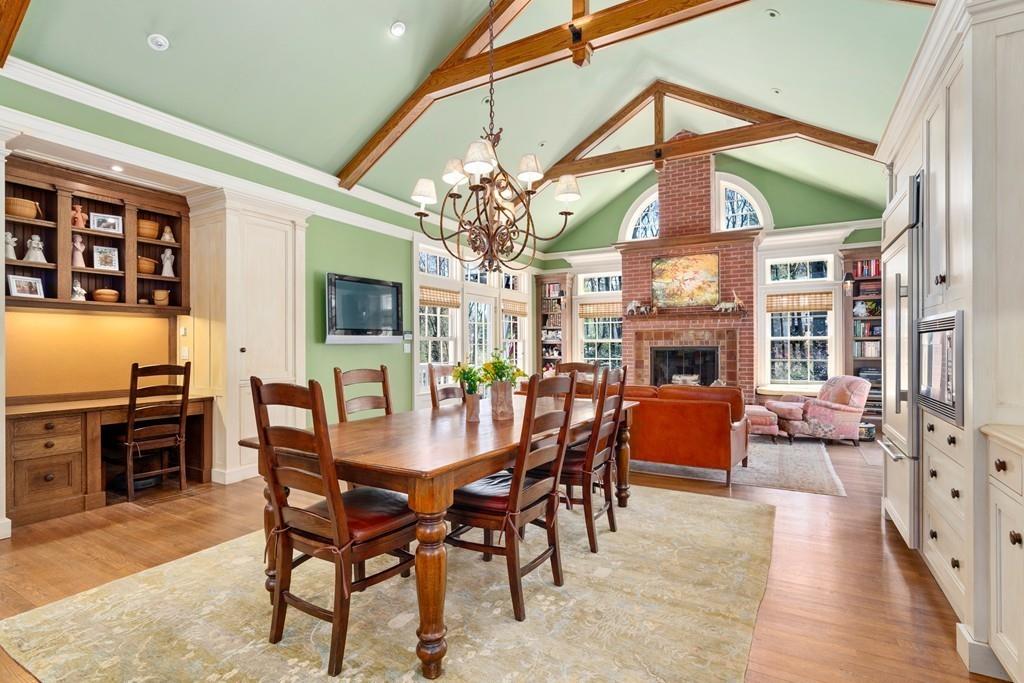 116 Meadowbrook Road Weston, MA 02493 - Photo 12 of 26 a dining room with furniture a fireplace and wooden floor