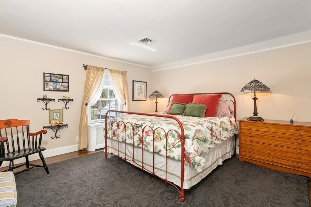 116 Meadowbrook Road Weston, MA 02493 - Photo 17 of 26 a bedroom with a bed and a lamp on table