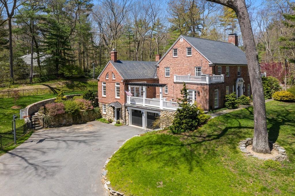 116 Meadowbrook Road Weston, MA 02493 - Photo 22 of 26 a front view of a house with a garden and trees
