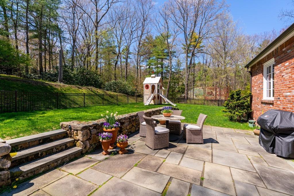 116 Meadowbrook Road Weston, MA 02493 - Photo 25 of 26 a view of a patio with table and chairs and a barbeque