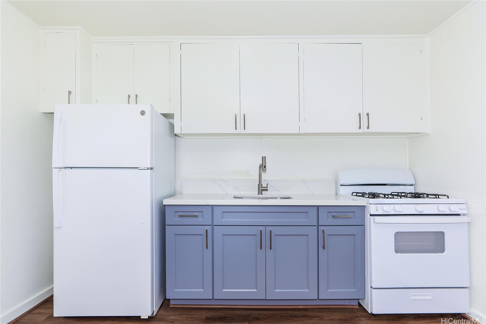 1719 Nuuanu Avenue, Unit 5F Honolulu, HI 96817 - Photo 12 of 25 a kitchen with cabinets appliances and a wooden floor