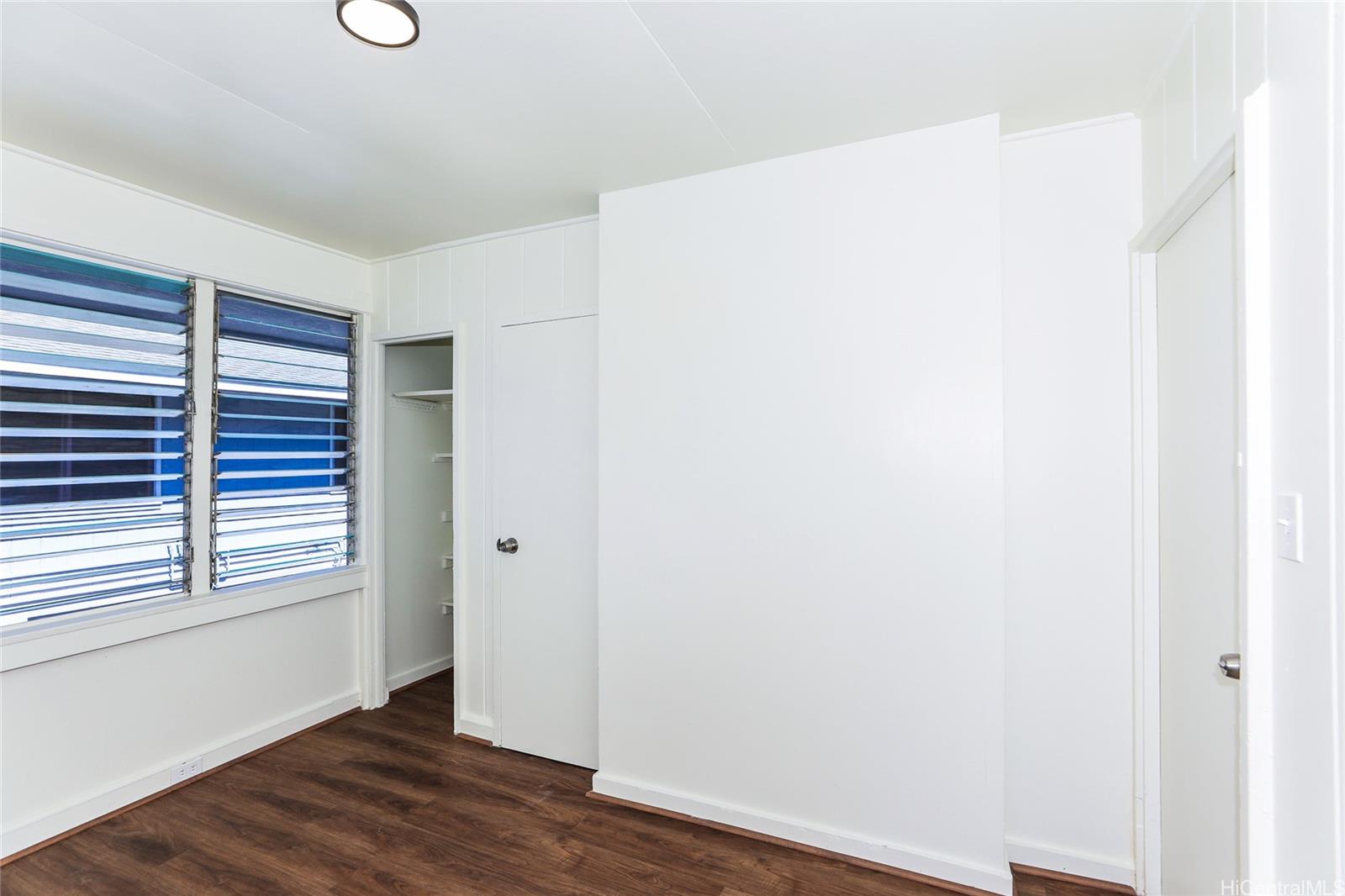 1719 Nuuanu Avenue, Unit 5F Honolulu, HI 96817 - Photo 14 of 25 a view of an empty room with wooden floor and a window