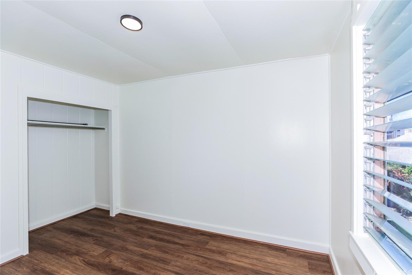 1719 Nuuanu Avenue, Unit 5F Honolulu, HI 96817 - Photo 18 of 25 a view of an empty room with wooden floor and a window