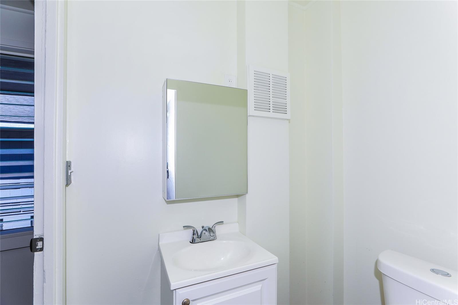 1719 Nuuanu Avenue, Unit 5F Honolulu, HI 96817 - Photo 19 of 25 a bathroom with a sink and a mirror