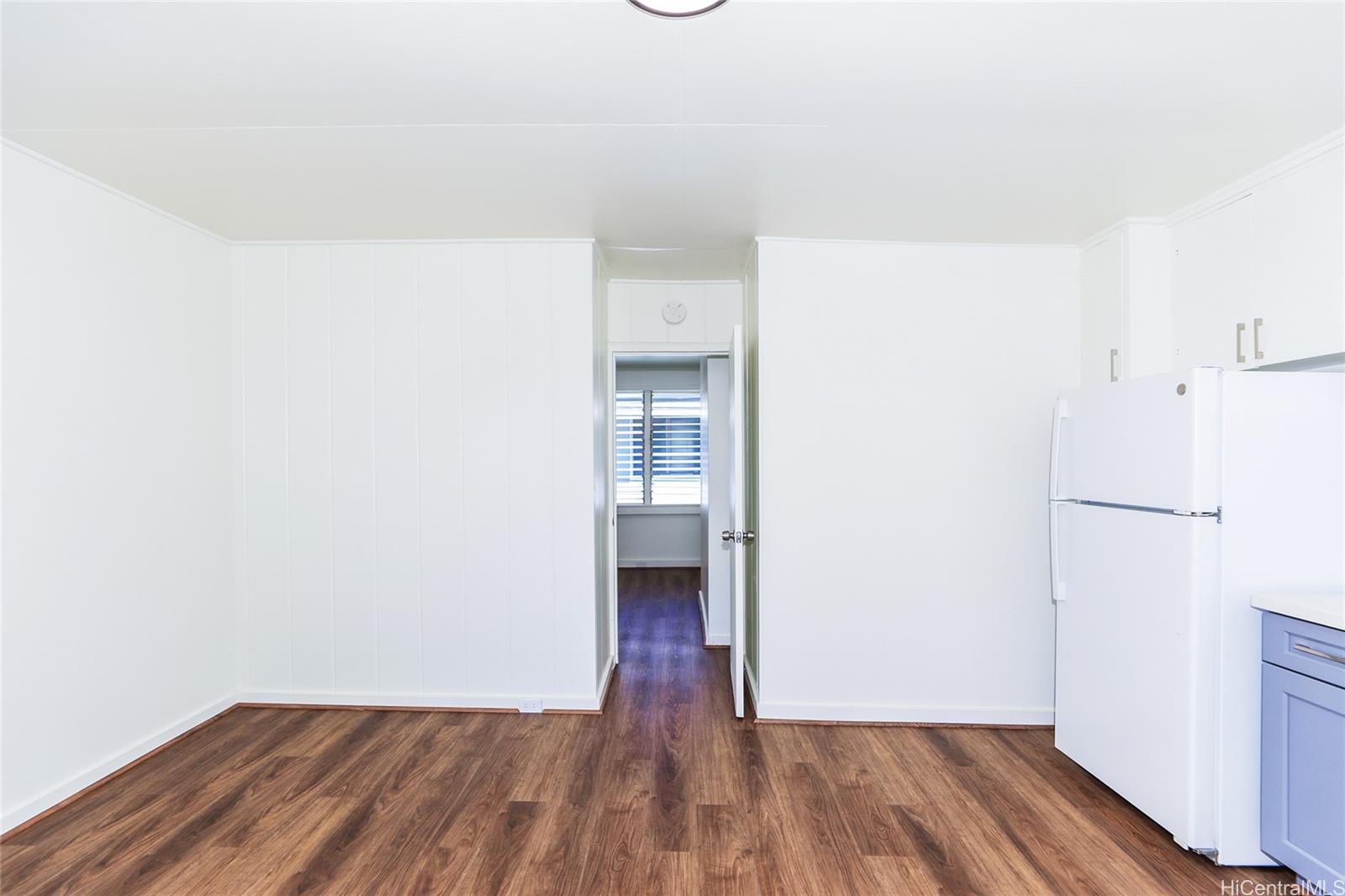 1719 Nuuanu Avenue, Unit 5F Honolulu, HI 96817 - Photo 4 of 25 a view of a room with wooden floor and a ceiling fan